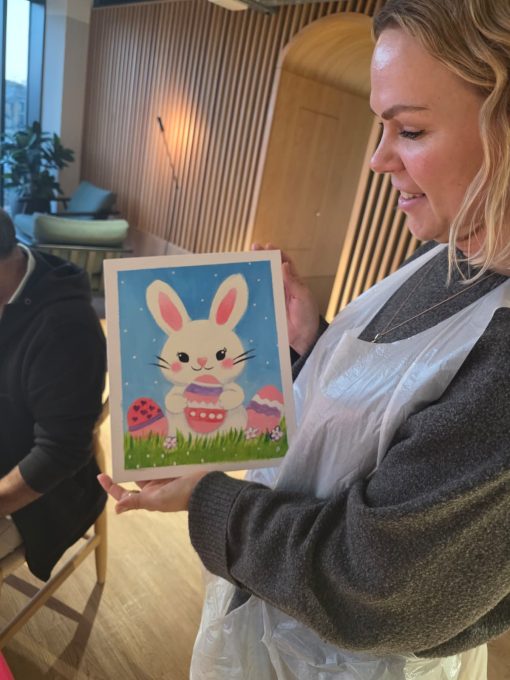 Art Club member showing her finished Easter bunny painting