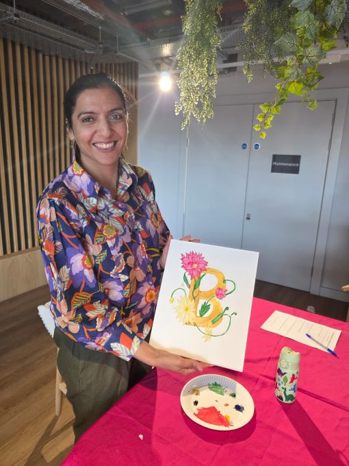 Art Club member smiling with her finished lotus flower painting