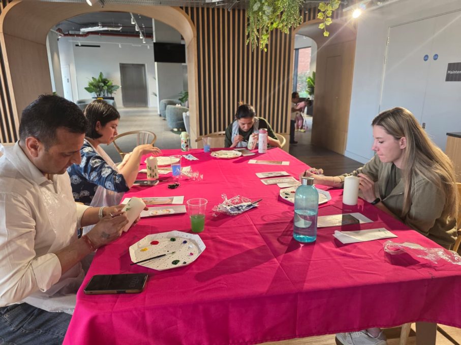 Art Club members painting at pink-clothed tables at One Maidenhead