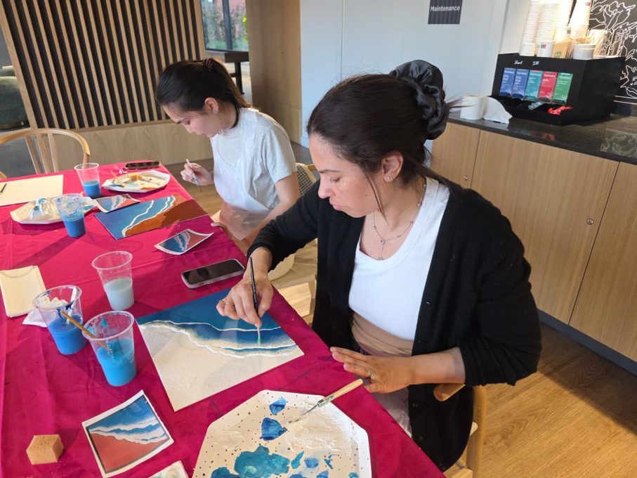 Art Club members painting blue and teal artworks