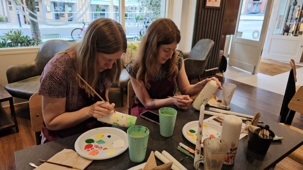 Two Art Club members painting side by side