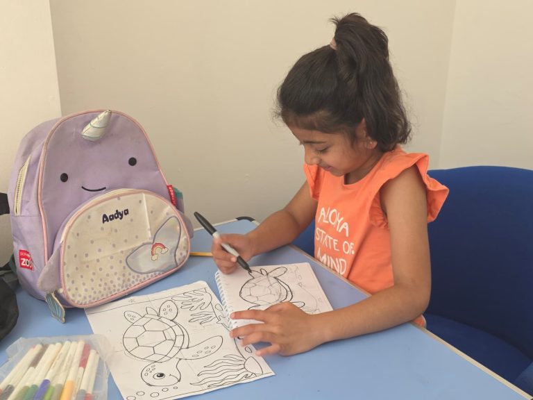 A young student concentrating while sketching in her art class