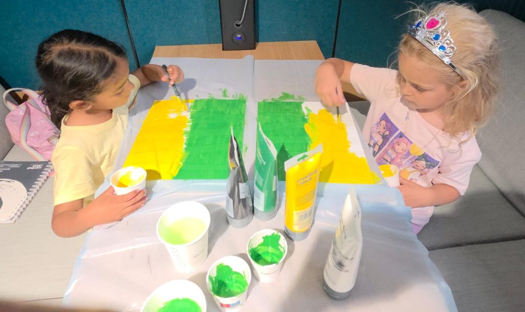 Two children choosing their own colours and design during class