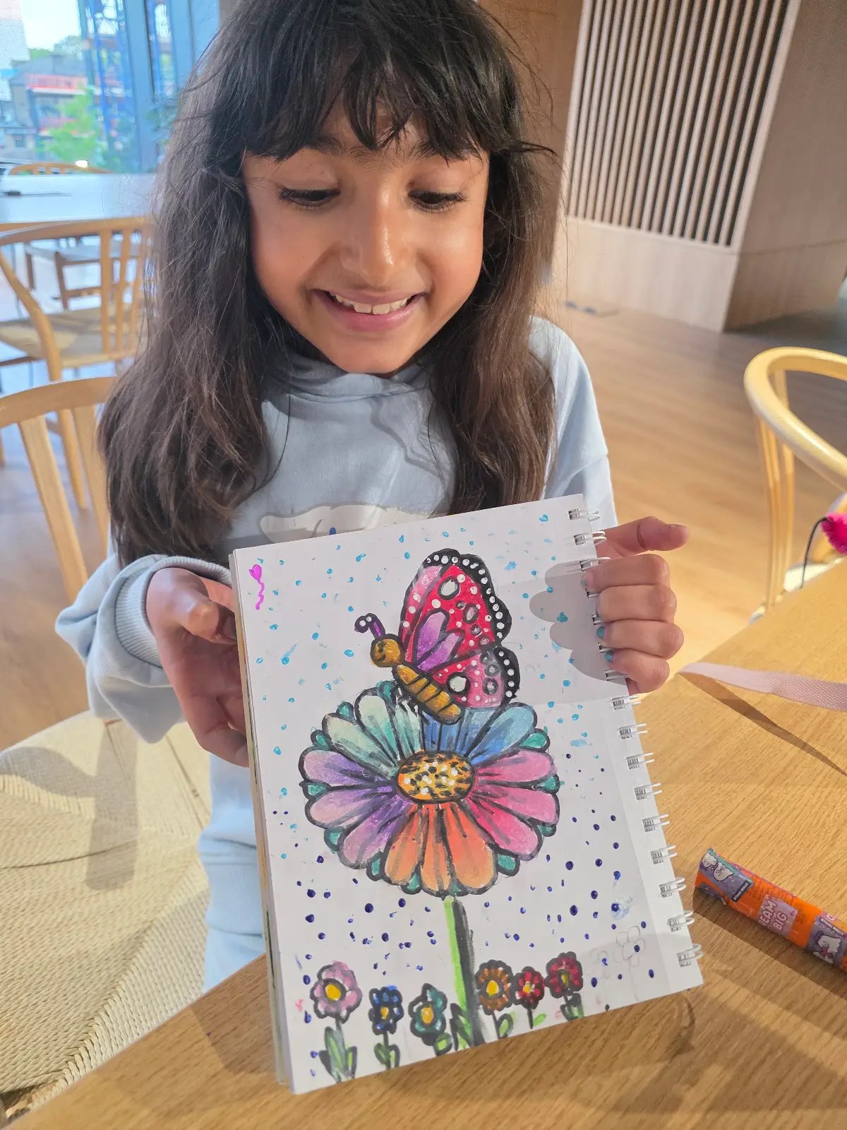 Devi Arts student with finished painting