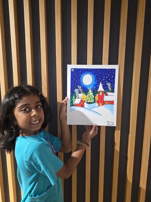 Devi Arts student with finished painting