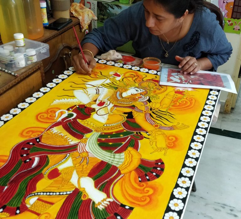 An artist at work on a mural-style painting