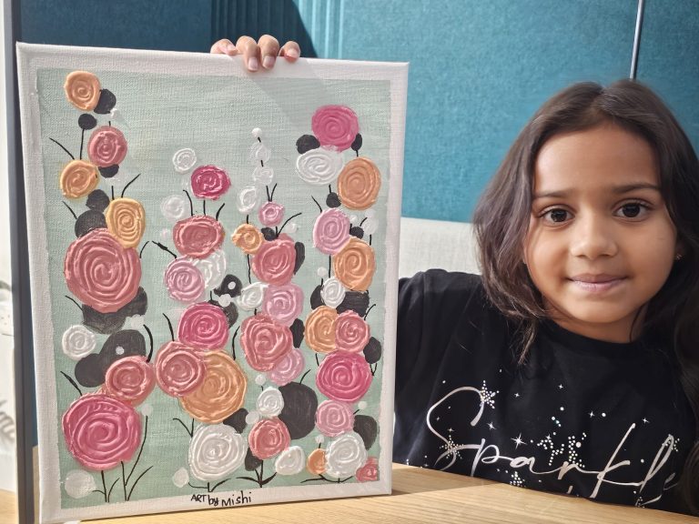A young UK student with her finished floral canvas